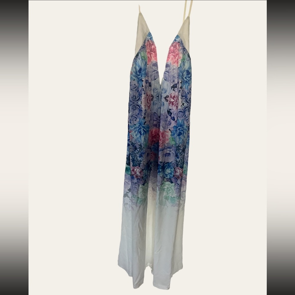 White dress with colorful floral pattern up top fading into white at the bottom